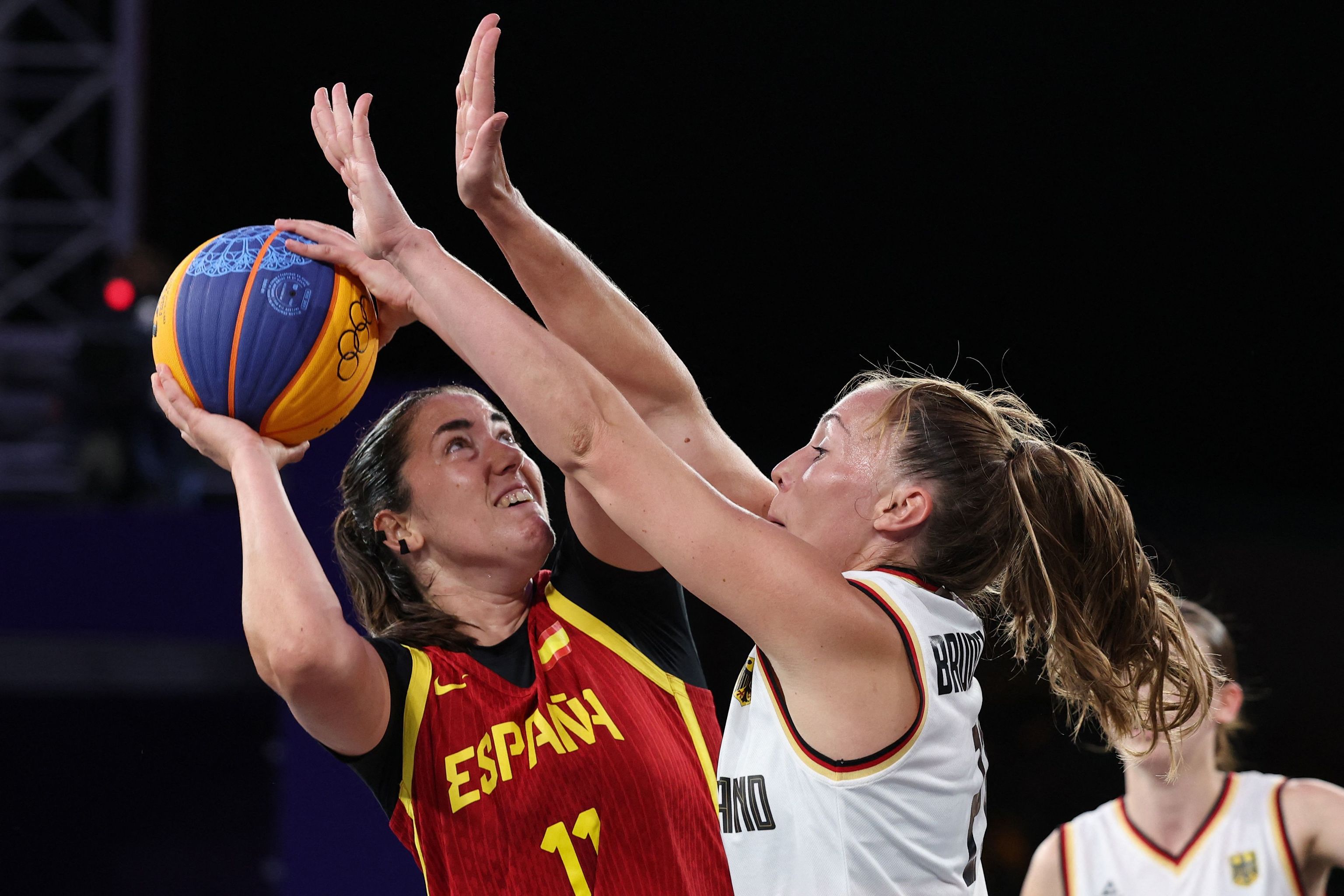 Spain's #11 Vega Gimeno and Germany's #21 Svenja Brunckhorst compete in the women's  lt;HIT gt;3x3 lt;/HIT gt; basketball gold medal game between Germany and Spain during the Paris 2024 Olympic Games at La Concorde in Paris on August 5, 2024. (Photo by David GRAY / AFP)