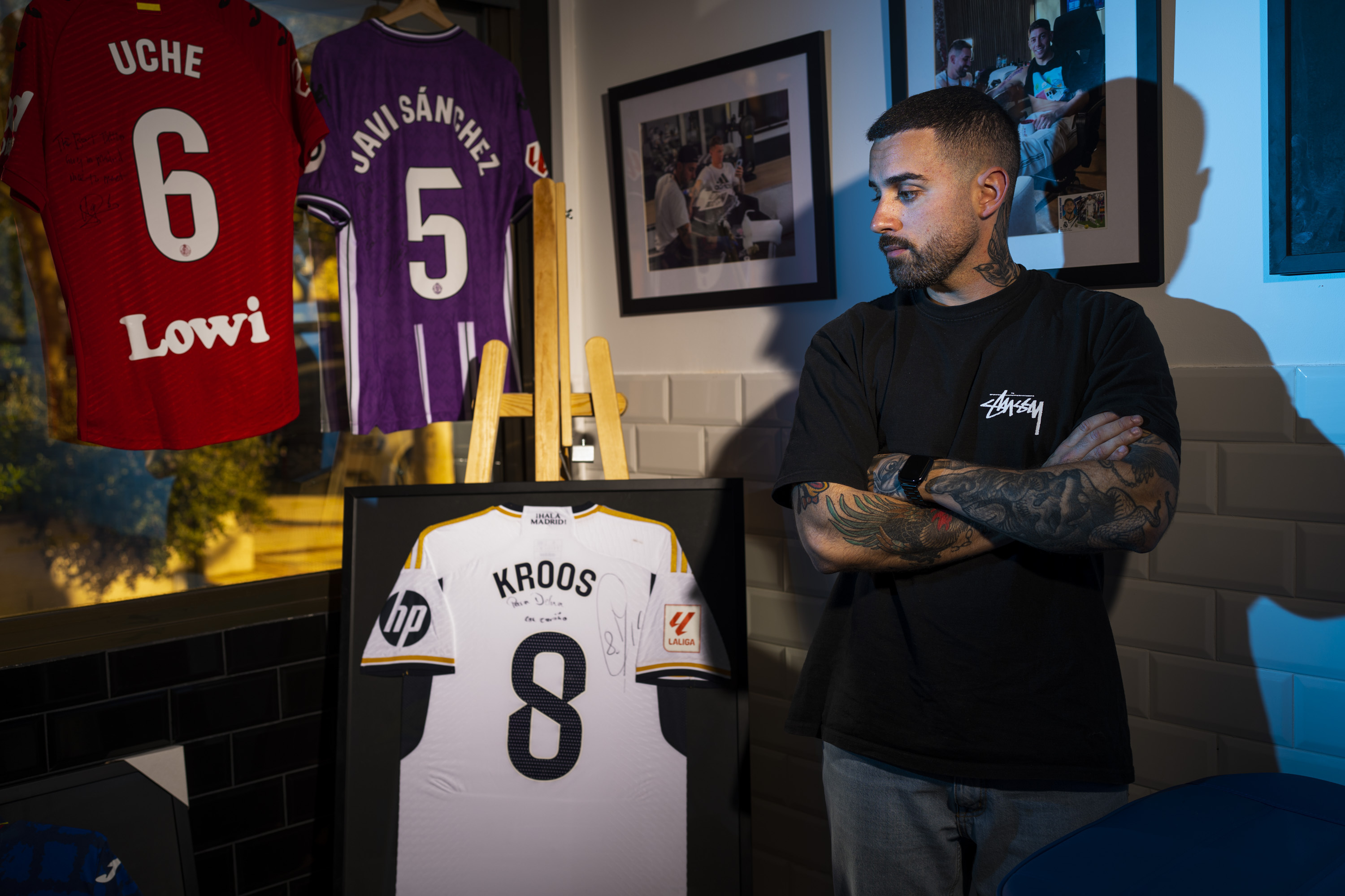 Del Mazo, con las camisetas y fotos de alguno de los futbolistas a los que ha tatuado.