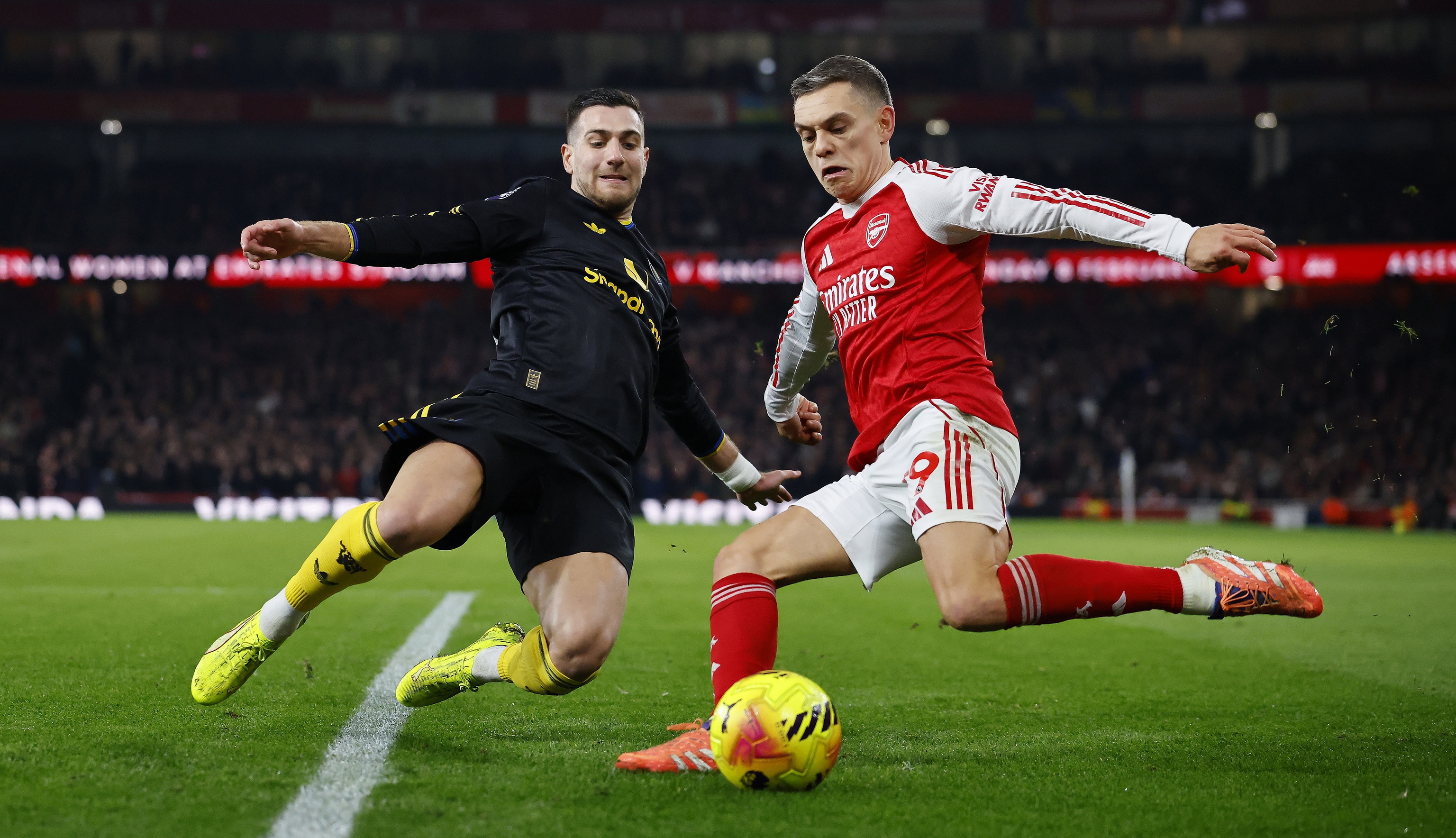 Dalot, frente a Trossard, el domingo en el Emirates.